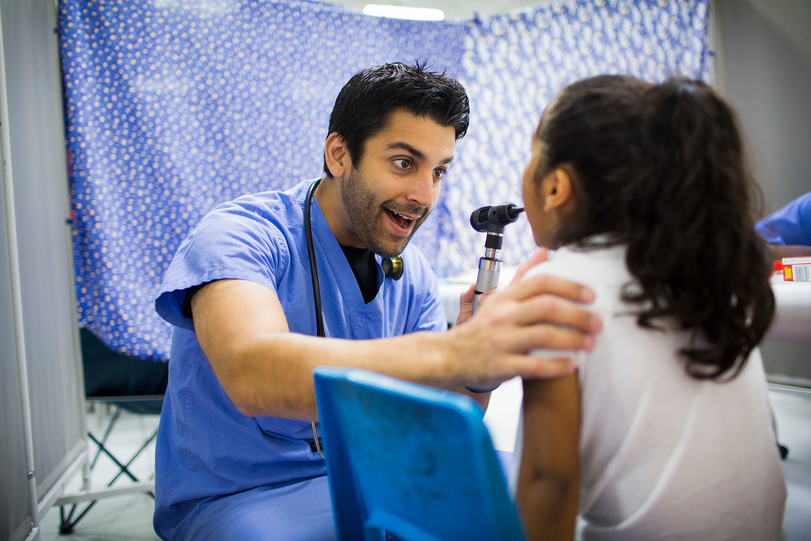 a little girl in the doctor's office being examined by a doctor 